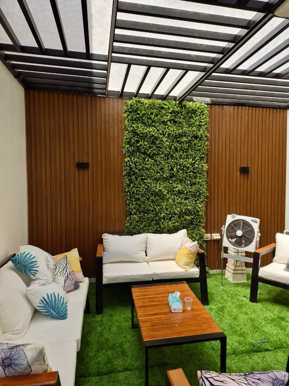 Artificial turf floor running the length of the courtyard