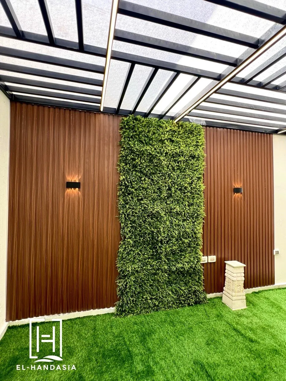 Courtyard lounge lit after dark with warm concealed lighting
