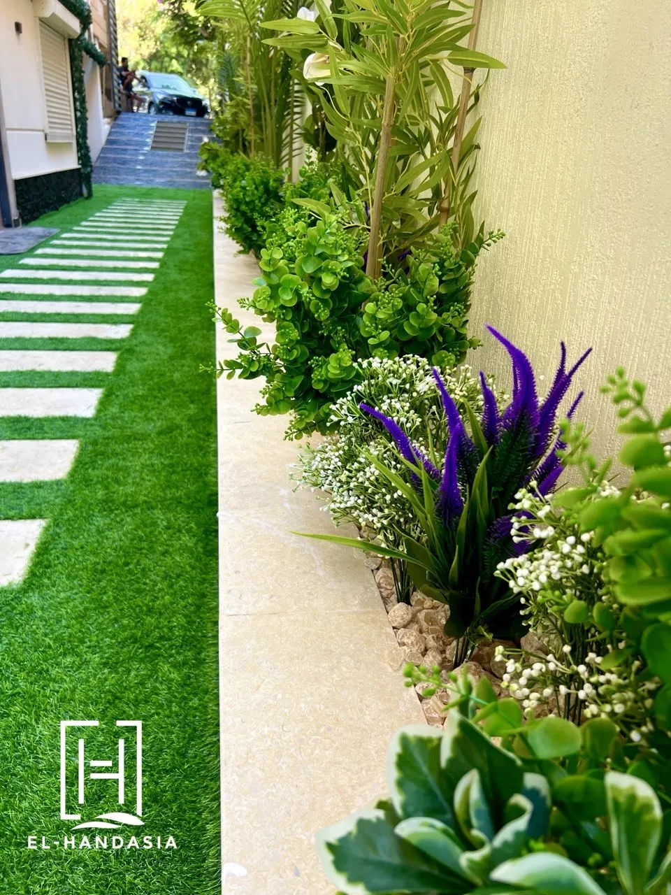 Travertine stepping slabs set into artificial turf