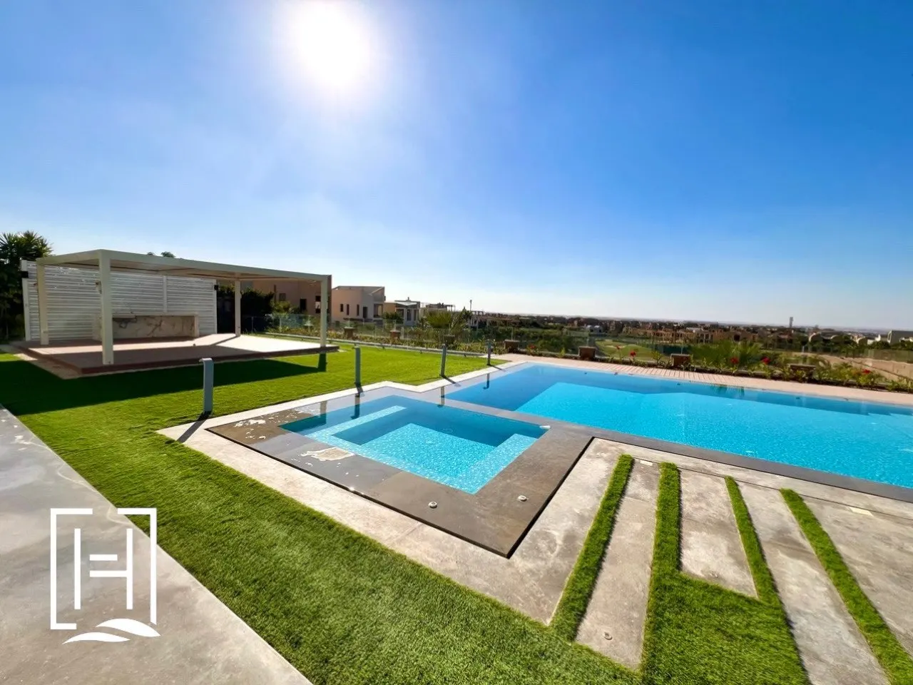 Overflow pool and timber terrace in a Sheikh Zayed villa garden